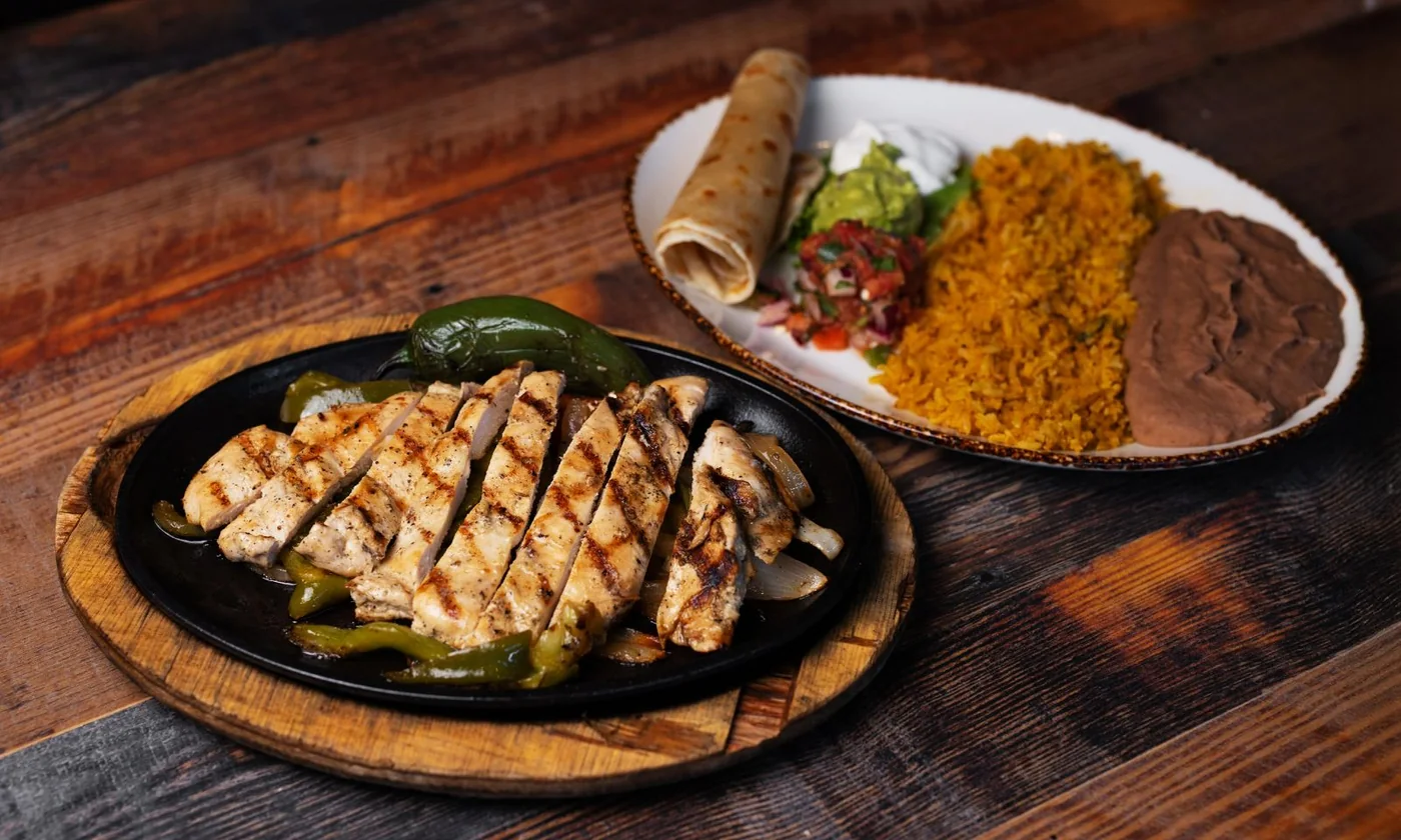 Sizzling fajitas with tortillas and sides